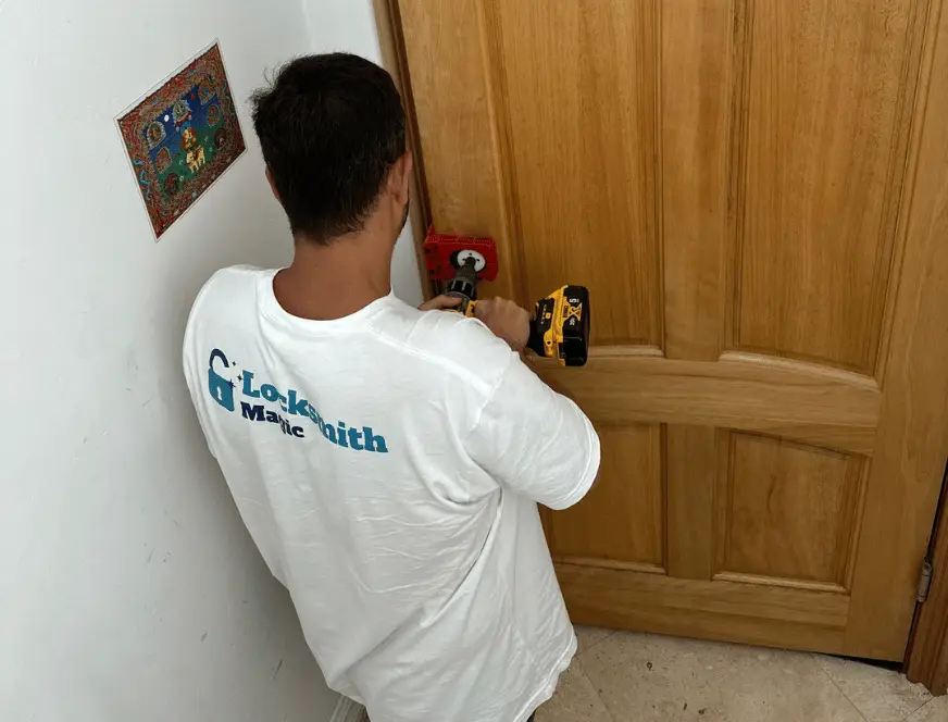Locksmith Magic technician drilling and installing a new door lock at a San Diego home