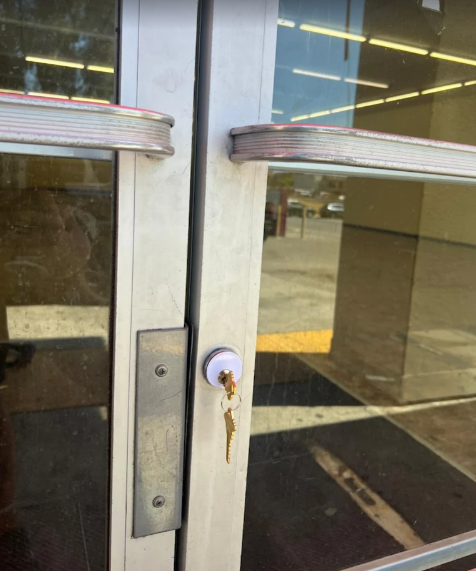 Commercial storefront glass door with a freshly installed lock cylinder and keys by Locksmith Magic in San Diego