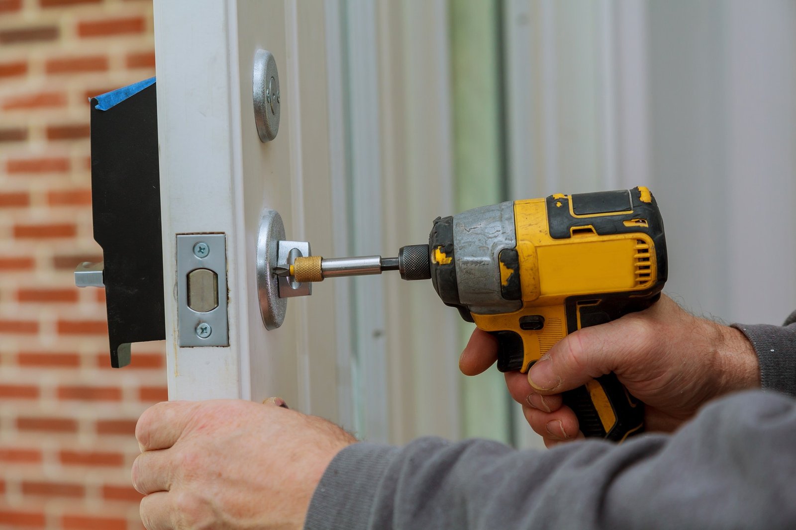 Installing a commercial door lock with a power drill