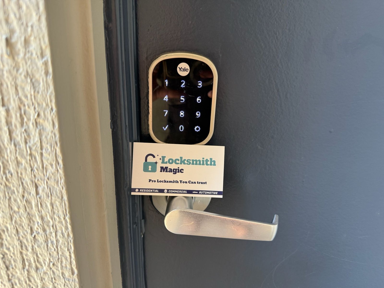 Yale smart lock installed by Locksmith Magic with business card