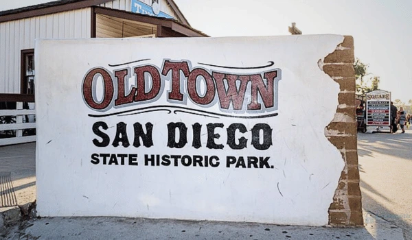Locksmith Magic van parked near Presidio Park and Old Town San Diego sign — offering mobile locksmith, car key replacement, and lockout services across 92110